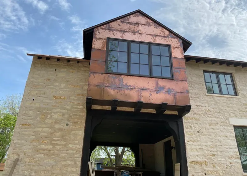 Copper metal panel facade on a stone building for Skylight Installation in Goodlettsville